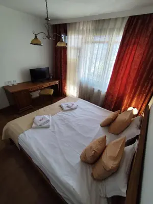 a bedroom with a bed with white sheets and pillows at Mountain View ECOVILLA in Devin