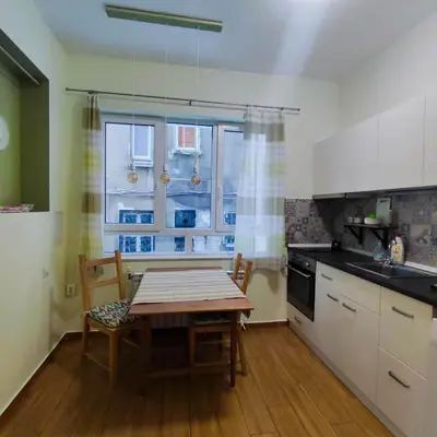 a kitchen with a table and chairs and a window at NDK Central Home in Sofia