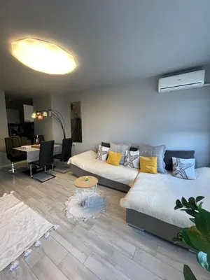 a living room with two beds and a table at Apartamento Estrella in Sofia