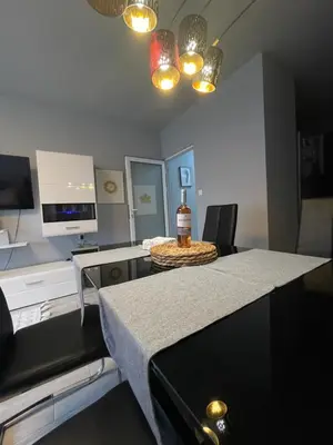 a kitchen with a table with a pizza on it at Apartamento Estrella in Sofia