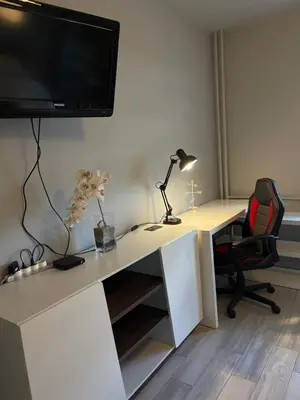 an office with a desk with a tv and a chair at Apartamento Estrella in Sofia