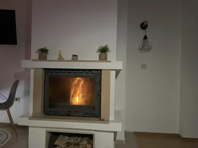 a fireplace in the corner of a living room at Nest by the Peaks Apartment in Bansko in Bansko