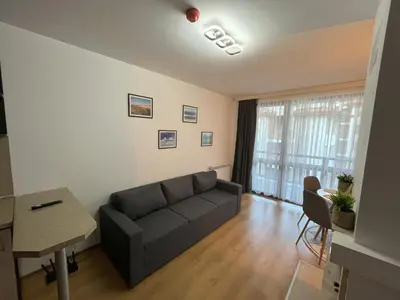 a living room with a couch and a table at Nest by the Peaks Apartment in Bansko in Bansko