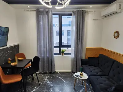 a living room with a couch and a table at luxury Apartament TD one bedroom in Sofia