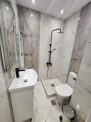a white bathroom with a toilet and a sink at luxury Apartament TD one bedroom in Sofia