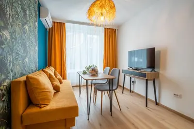 a living room with a couch and a table at Exotic apartment in Sofia