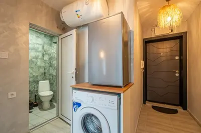 a washing machine in a bathroom with a toilet at Exotic apartment in Sofia