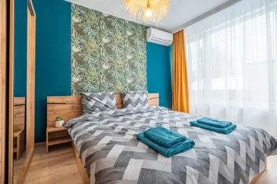 a bedroom with a bed with two pillows on it at Exotic apartment in Sofia