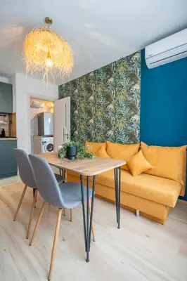 a living room with a table and a couch at Exotic apartment in Sofia