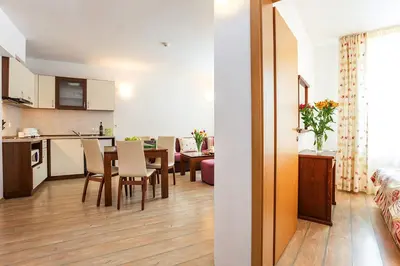 a kitchen and living room with a table and chairs at Fantastic 1-bedroom apartment Stream Resort in Pamporovo