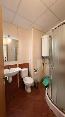 a bathroom with a toilet and a sink and a shower at Fantastic 1-bedroom apartment Stream Resort in Pamporovo
