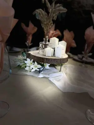a table with a tray with candles and flowers on it at Вила Китна in Lozno