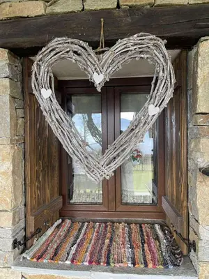 a heart shaped wreath is hanging on a window at Вила Китна in Lozno