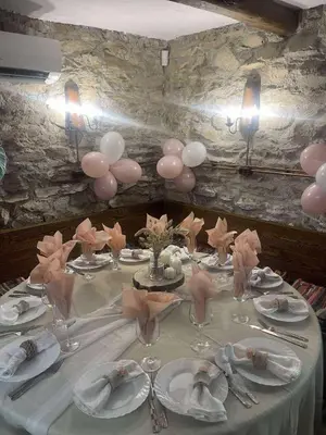 a table with pink balloons and glasses on it at Вила Китна in Lozno