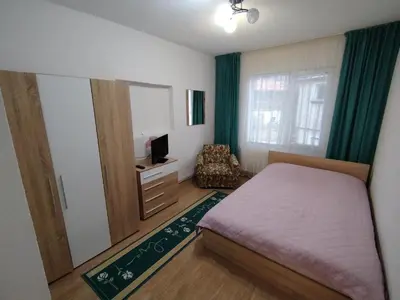 a bedroom with a bed and a mirror and a chair at Къща за гости ЖАНИ in Zmeitsa