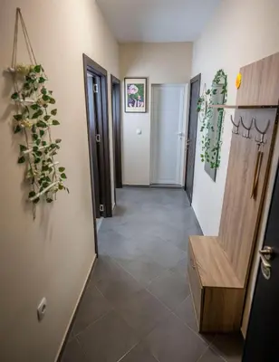a hallway with doors and a tile floor at Boho Floral Apartment near to Old Town in Plovdiv
