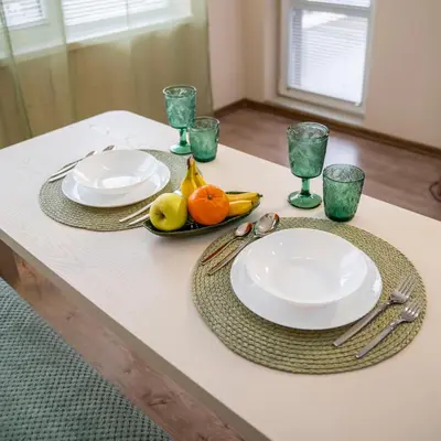 a table with two plates and bowls of fruit on it at Boho Floral Apartment near to Old Town in Plovdiv