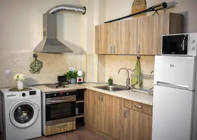 a kitchen with a white refrigerator and a dishwasher at Boho Floral Apartment near to Old Town in Plovdiv