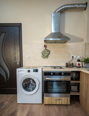 a kitchen with a stove and a washing machine at Boho Floral Apartment near to Old Town in Plovdiv