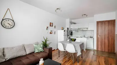 a living room and kitchen with a couch and a table at Terra Vibes - Central 1BD with balcony by Flat Mаnager in Sofia