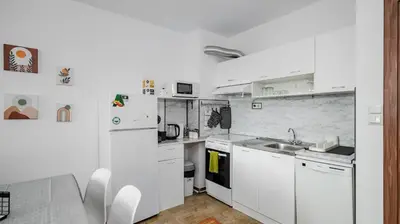 a white kitchen with a sink and a refrigerator at Terra Vibes - Central 1BD with balcony by Flat Mаnager in Sofia