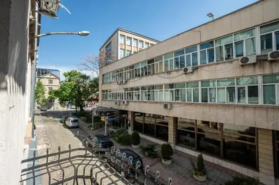 a building with cars parked in front of it at Salts Market 3BR Retreat in Sofia