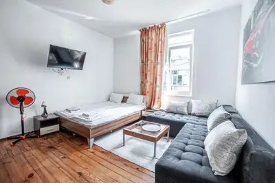 a living room with a couch and a bed at Salts Market 3BR Retreat in Sofia
