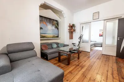 a living room with a couch and a glass table at Salts Market 3BR Retreat in Sofia