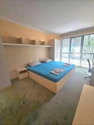 a bedroom with a bed and a large window at Nexus of Power in Sofia