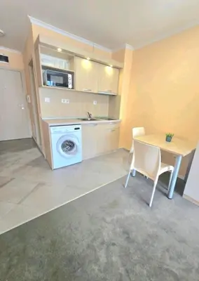 a kitchen with a table and a washing machine in it at Nexus of Power in Sofia