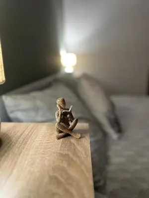 a small figurine sitting on top of a bed at Bansko Gondola Apart in Bansko