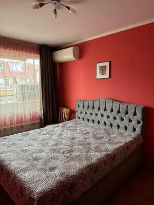 a bedroom with a bed and a red wall at Top-View Terrace 2BD Central Apt in Sofia