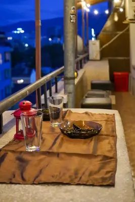a table with a bowl and two glasses on a balcony at Top-View Terrace 2BD Central Apt in Sofia