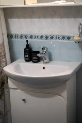 a bathroom sink with two bottles of soap on it at Top-View Terrace 2BD Central Apt in Sofia