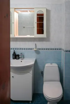 a bathroom with a toilet and a sink and a mirror at Top-View Terrace 2BD Central Apt in Sofia