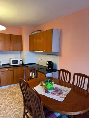 a kitchen with a wooden table with chairs and a kitchenasteryasteryasteryasteryastery at Top-View Terrace 2BD Central Apt in Sofia