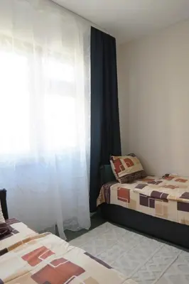a bedroom with two beds and a window at Полименови in Sofia