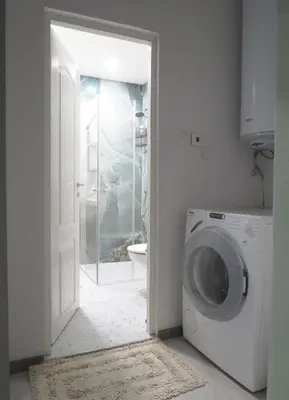 a laundry room with a washing machine in a bathroom at Полименови in Sofia
