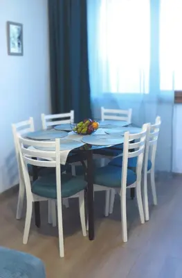 a table with chairs and a bowl of fruit on it at Полименови in Sofia