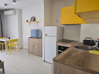 a kitchen with a white refrigerator and a table at The Peak in Sofia