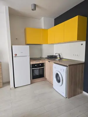 a kitchen with a white refrigerator and a dishwasher at The Peak in Sofia