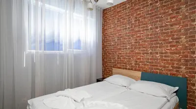 a bed in a room with a brick wall at Central Cozy 1BD Compact Chic Living by Flat Mаnager in Sofia