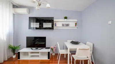 a dining room with a white table and chairs at Central Cozy 1BD Compact Chic Living by Flat Mаnager in Sofia