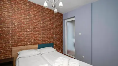 a bedroom with a brick wall and a bed at Central Cozy 1BD Compact Chic Living by Flat Mаnager in Sofia