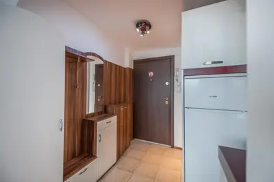 a small kitchen with a refrigerator and a door at Central Cozy 1BD Compact Chic Living by Flat Mаnager in Sofia