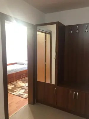 a room with a closet and a bedroom with a bed at При Бети in Sandanski