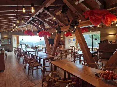 a row of tables and chairs in a restaurant at Хотел Гела in Gela