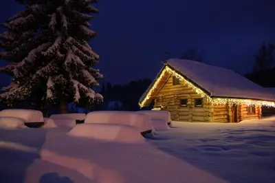 a cabin covered in snow with a christmas tree at Хотел Гела in Gela