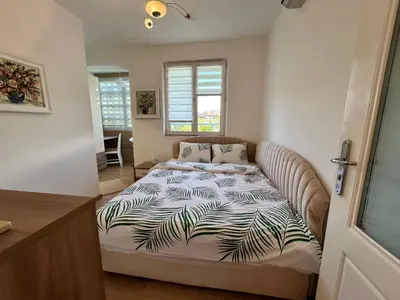 a bedroom with a bed with a comforter on it at MirrArt House - Просторен луксозен апартамент - 3 спални - 2 бани - Топ център in Plovdiv