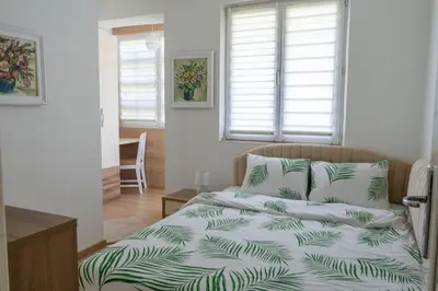 a bedroom with a bed with a green and white comforter at MirrArt House - Просторен луксозен апартамент - 3 спални - 2 бани - Топ център in Plovdiv